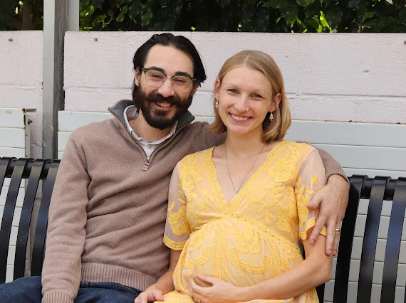 Nick and his wife sitting together outdoors.